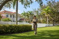 Landscape specialist inspecting a residential property