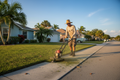 Landscaper edging along a sidewalk with a power edger