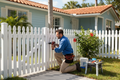 Handyman making exterior repair on Florida property
