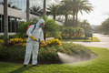 Technician applying IPM treatment to commercial landscape